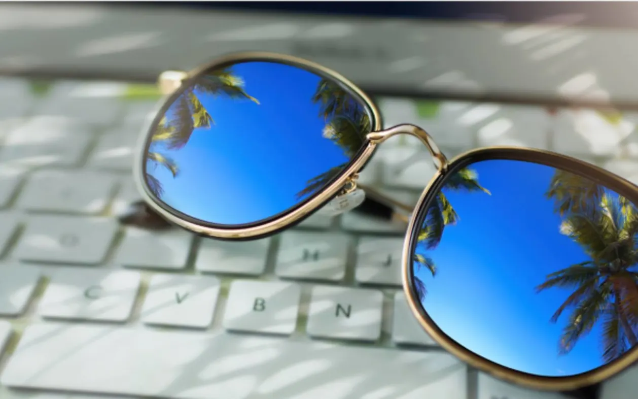 workation dream sunglasses on laptop keyboard